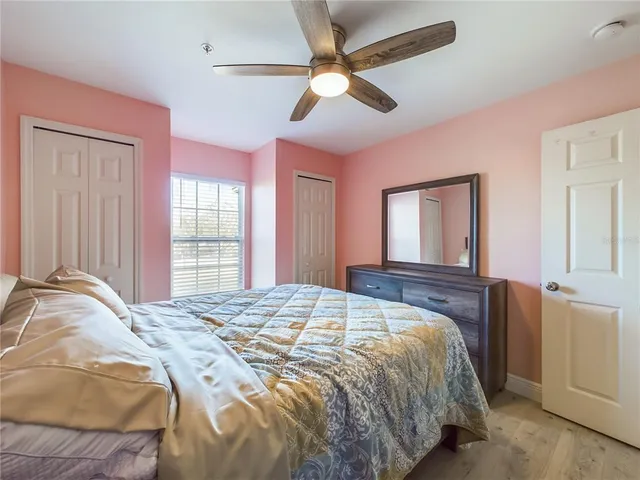 a bedroom with a large bed and a window