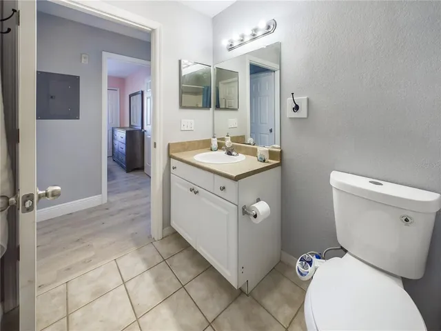 a spacious bathroom with a toilet sink and mirror