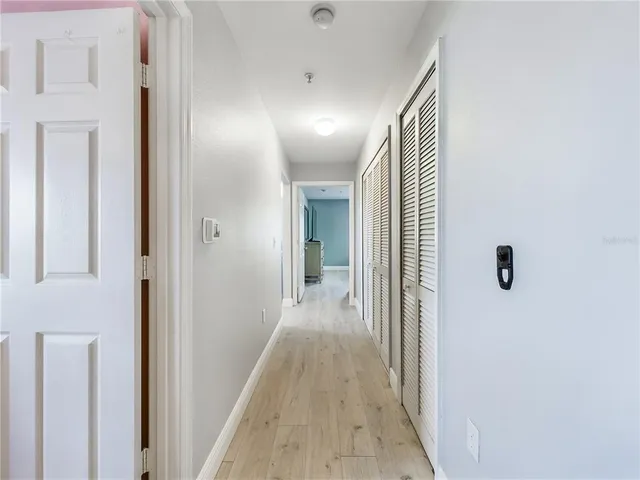 a view of hallway with wooden floor