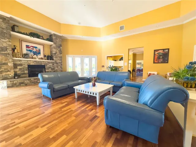 a living room with furniture and large windows