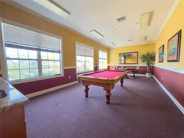 a large kitchen with a lot of counter space and a wooden floor
