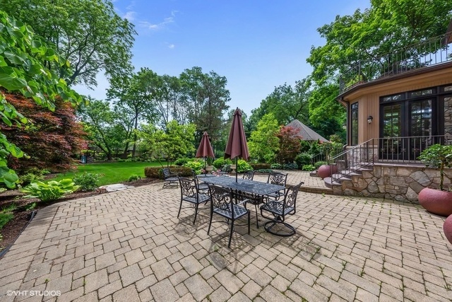 561 Walker Road Hinsdale, IL 60521 - Photo 30 of 41 a view of a patio with table and chairs potted plants and a large tree