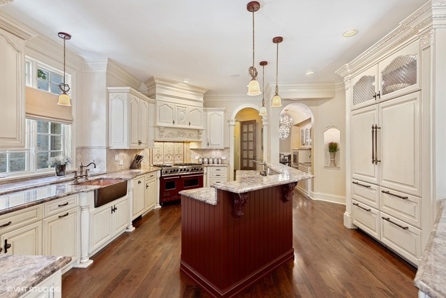 561 Walker Road Hinsdale, IL 60521 - Photo 6 of 41 a large kitchen with stainless steel appliances and chandelier