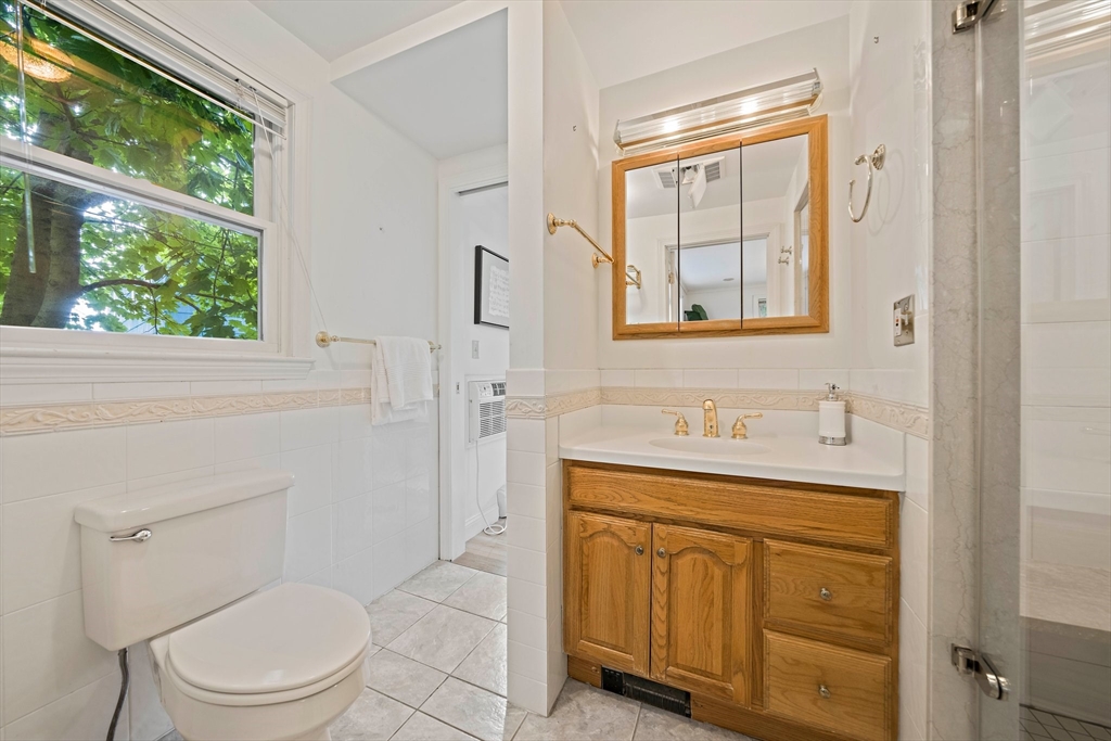 34 Wayburn Road Boston, MA 02130 - Photo 22 of 35 a bathroom with a toilet a sink a vanity and windows