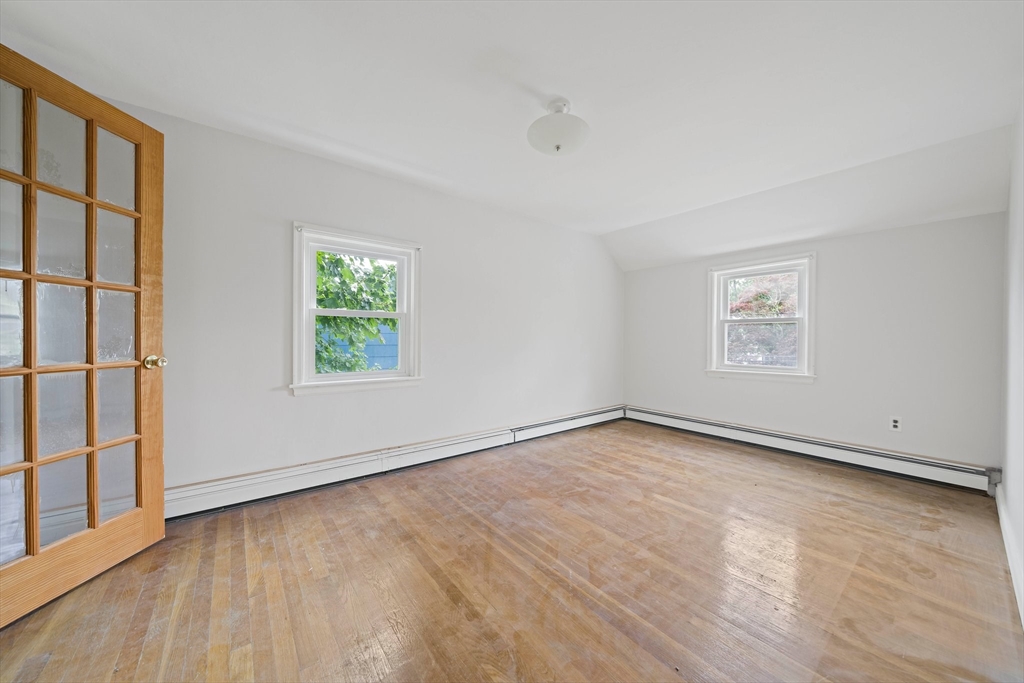 34 Wayburn Road Boston, MA 02130 - Photo 26 of 35 an empty room with wooden floor and windows