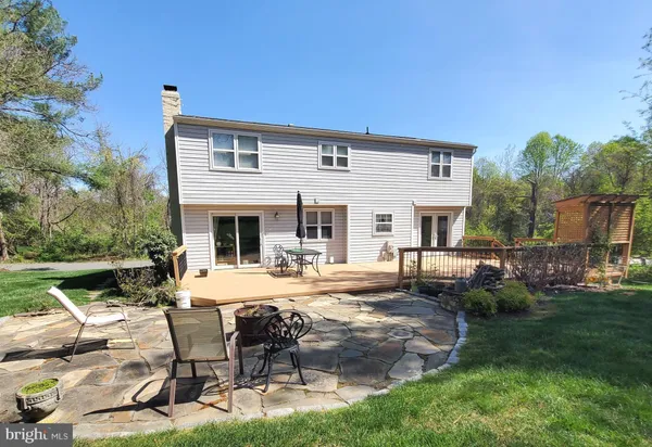 a view of a house with backyard porch and sitting area