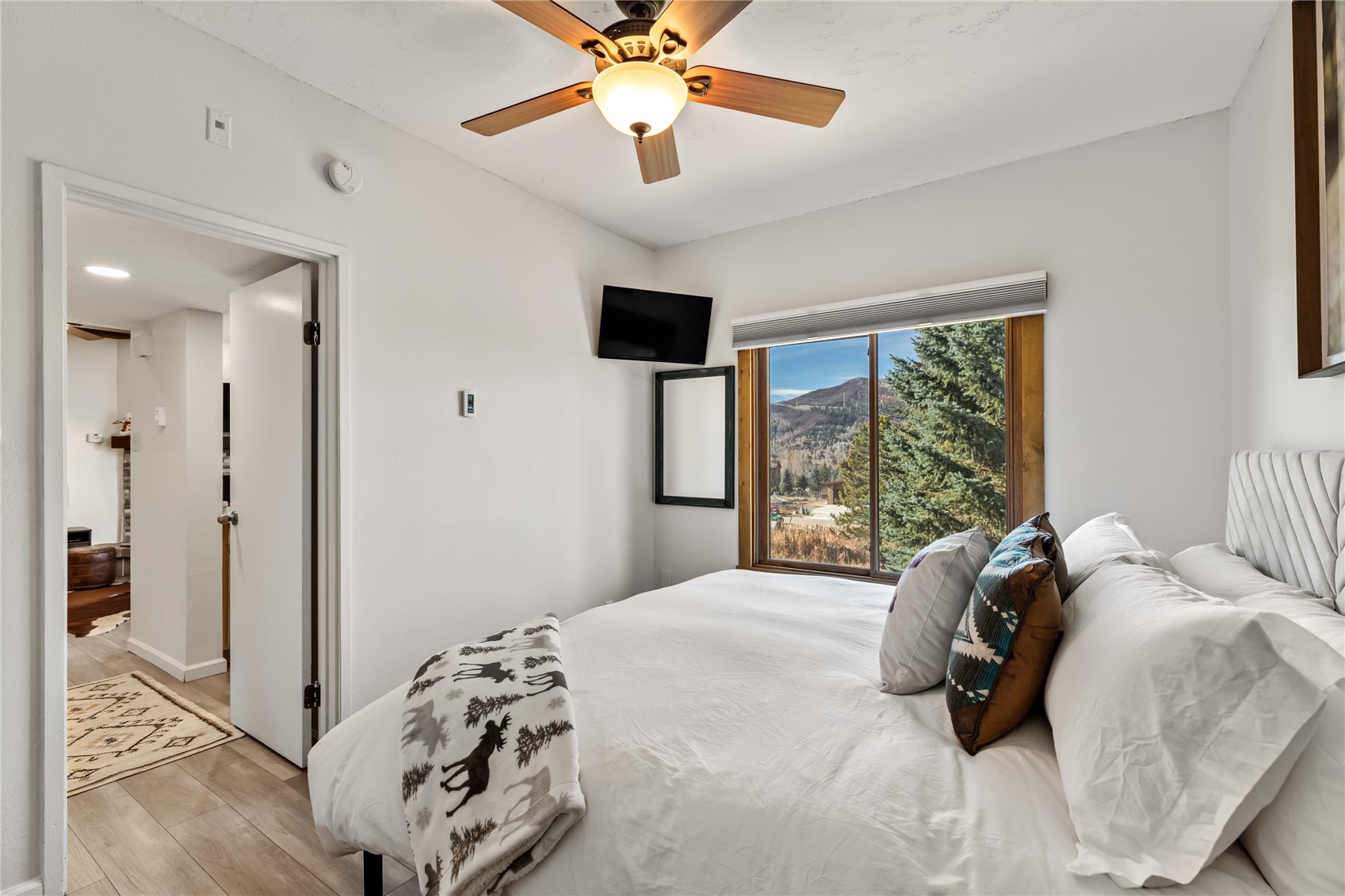 1945 Cornice Road, Unit 2224 Steamboat Springs, CO 80487 - Photo 12 of 22 Bedroom with light wood-type flooring and ceiling fan
