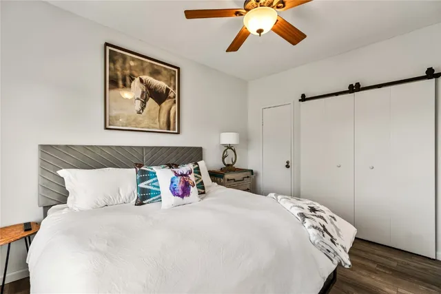 a bedroom with a bed and a painting on the wall