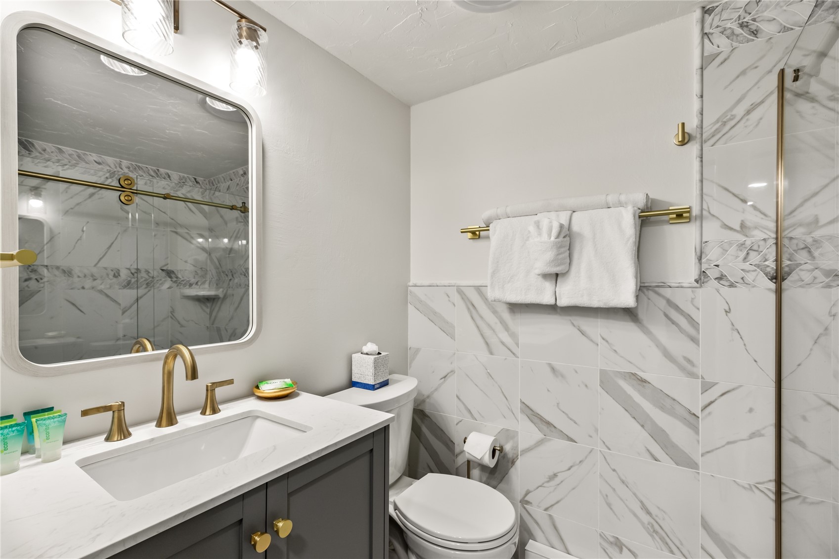 1945 Cornice Road, Unit 2224 Steamboat Springs, CO 80487 - Photo 14 of 22 Bathroom featuring tile walls, vanity, toilet, and a shower with door
