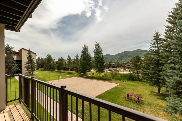 a view of a balcony with yard