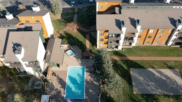 an aerial view of multiple houses with yard