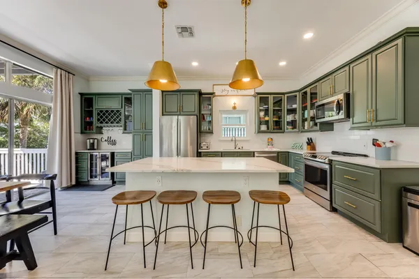 a kitchen with stainless steel appliances granite countertop a stove a sink and a microwave