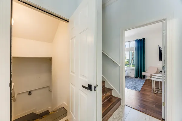 a living room with furniture and a dining table with kitchen view
