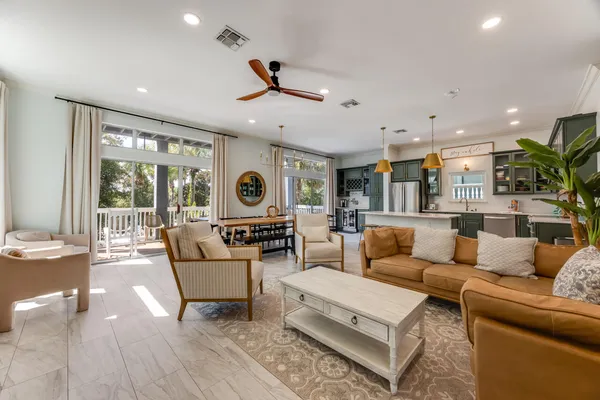 a living room with furniture kitchen view and a fireplace