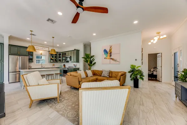a living room with furniture and a floor to ceiling window