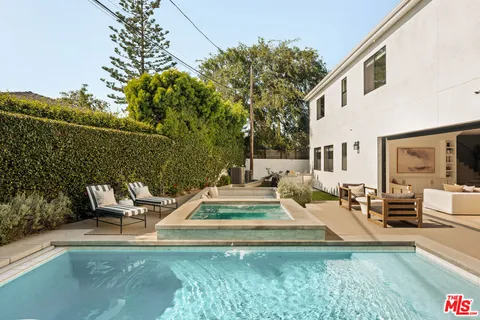 a view of a patio with couches chairs and potted plants