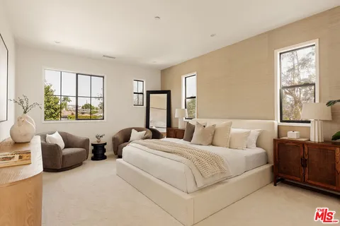 a bedroom with bed couch and window