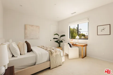 a bedroom with bed and a window