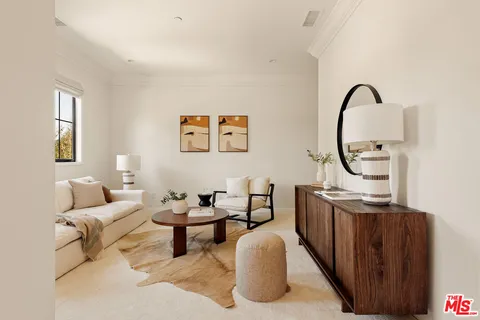 a living room with furniture a rug and a window