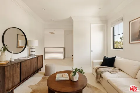 a living room with furniture a mirror and a window
