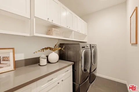 a view of storage and utility room with closet