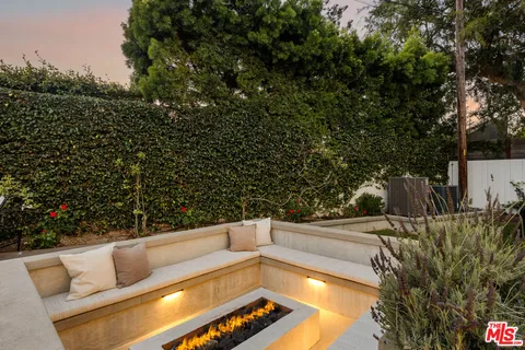a view of a back yard of the house with a street