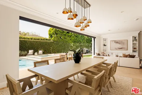 a view of a dining room with furniture large windows and wooden floor