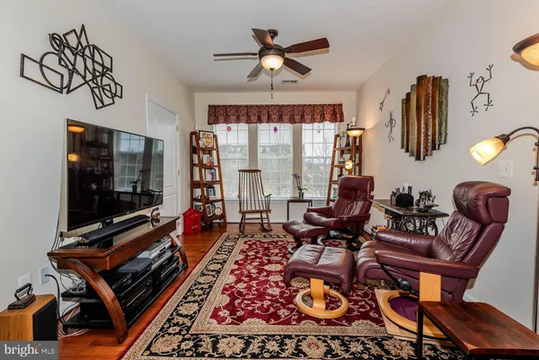 a view of a livingroom with furniture window and wooden floor