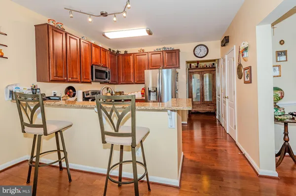 a kitchen with stainless steel appliances granite countertop a refrigerator stove and microwave