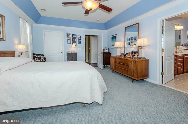 a bedroom with bed and a chandelier