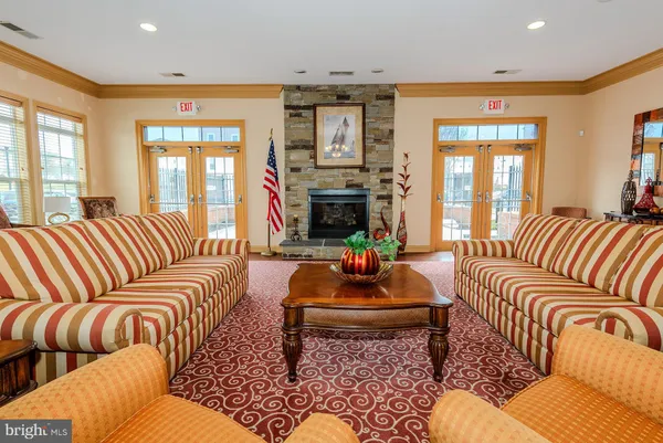 a living room with furniture a chandelier and a flat screen tv