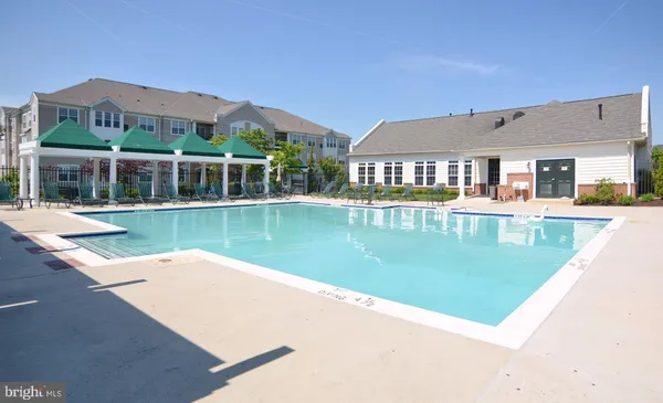 a view of a house with swimming pool and a yard