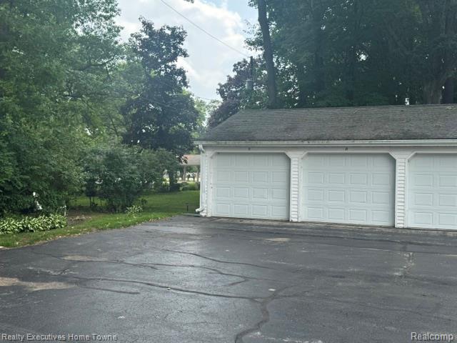 1467 Krafft Road, Unit 8 Port Huron, MI 48060 - Photo 2 of 28 Three-car garage with white panel doors and decorative trim columns