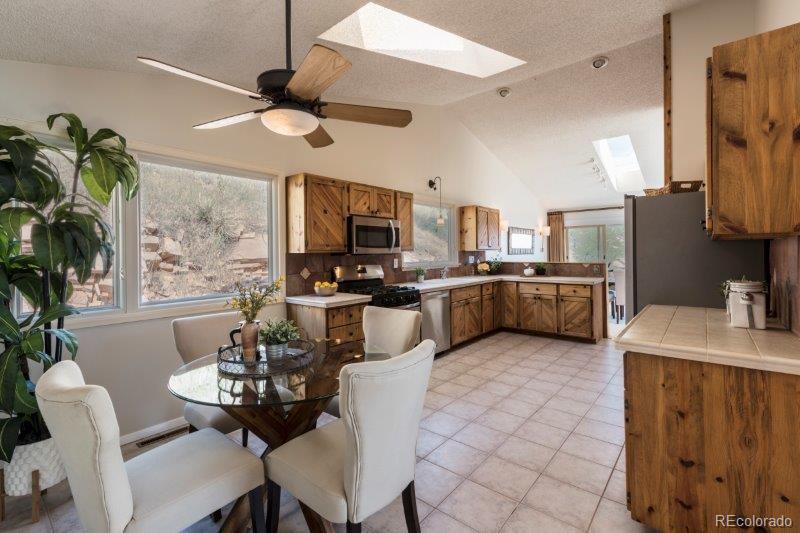 6513 Red Hill Road Boulder, CO 80302 - Photo 12 of 32 a living room with stainless steel appliances kitchen island granite countertop furniture and a kitchen view