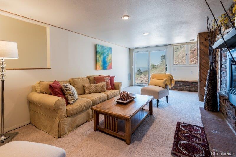6513 Red Hill Road Boulder, CO 80302 - Photo 20 of 32 a living room with furniture a rug and a window