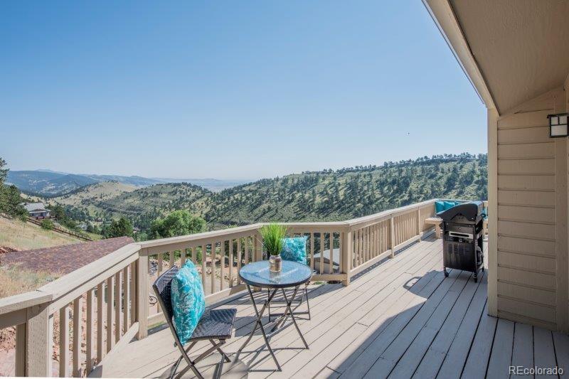 6513 Red Hill Road Boulder, CO 80302 - Photo 9 of 32 a view of a balcony with chairs and wooden floor