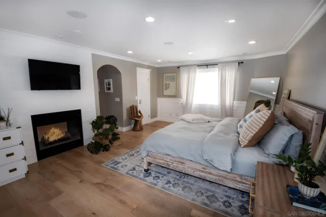 a spacious bedroom with a bed and a fireplace