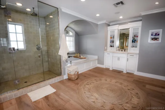 a spacious bathroom with a shower sink and mirror