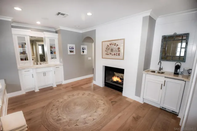 a view of livingroom with kitchen and fireplace