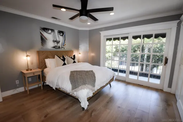 a bedroom with a large bed and a large window