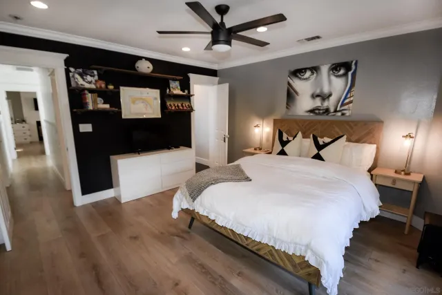 a bedroom with a bed and a flat screen tv