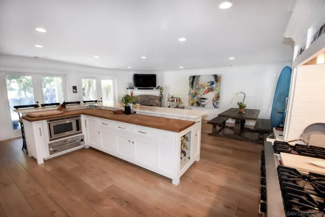 a view of kitchen with sink stove and refrigerator