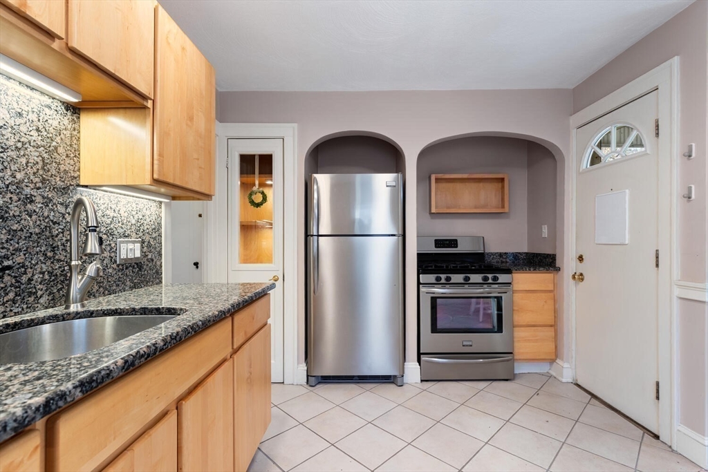9 Wildwood Road Medford, MA 02155 - Photo 12 of 38 a kitchen with stainless steel appliances granite countertop a refrigerator and a sink