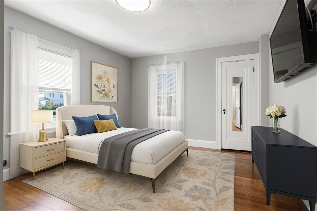 9 Wildwood Road Medford, MA 02155 - Photo 18 of 38 a spacious bedroom with a bed and a flat screen television
