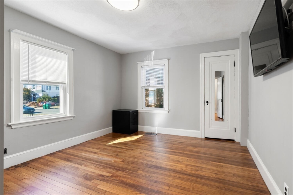 9 Wildwood Road Medford, MA 02155 - Photo 19 of 38 a view of empty room with wooden floor and fan