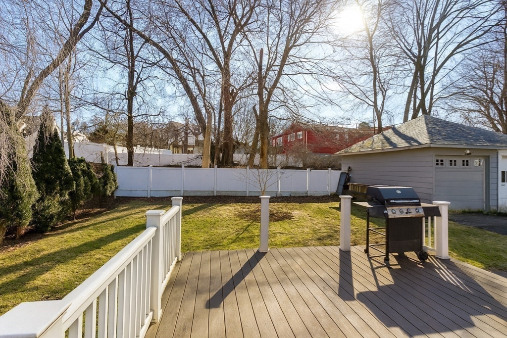 9 Wildwood Road Medford, MA 02155 - Photo 34 of 38 a view of a patio with chairs next to a yard with a large tree