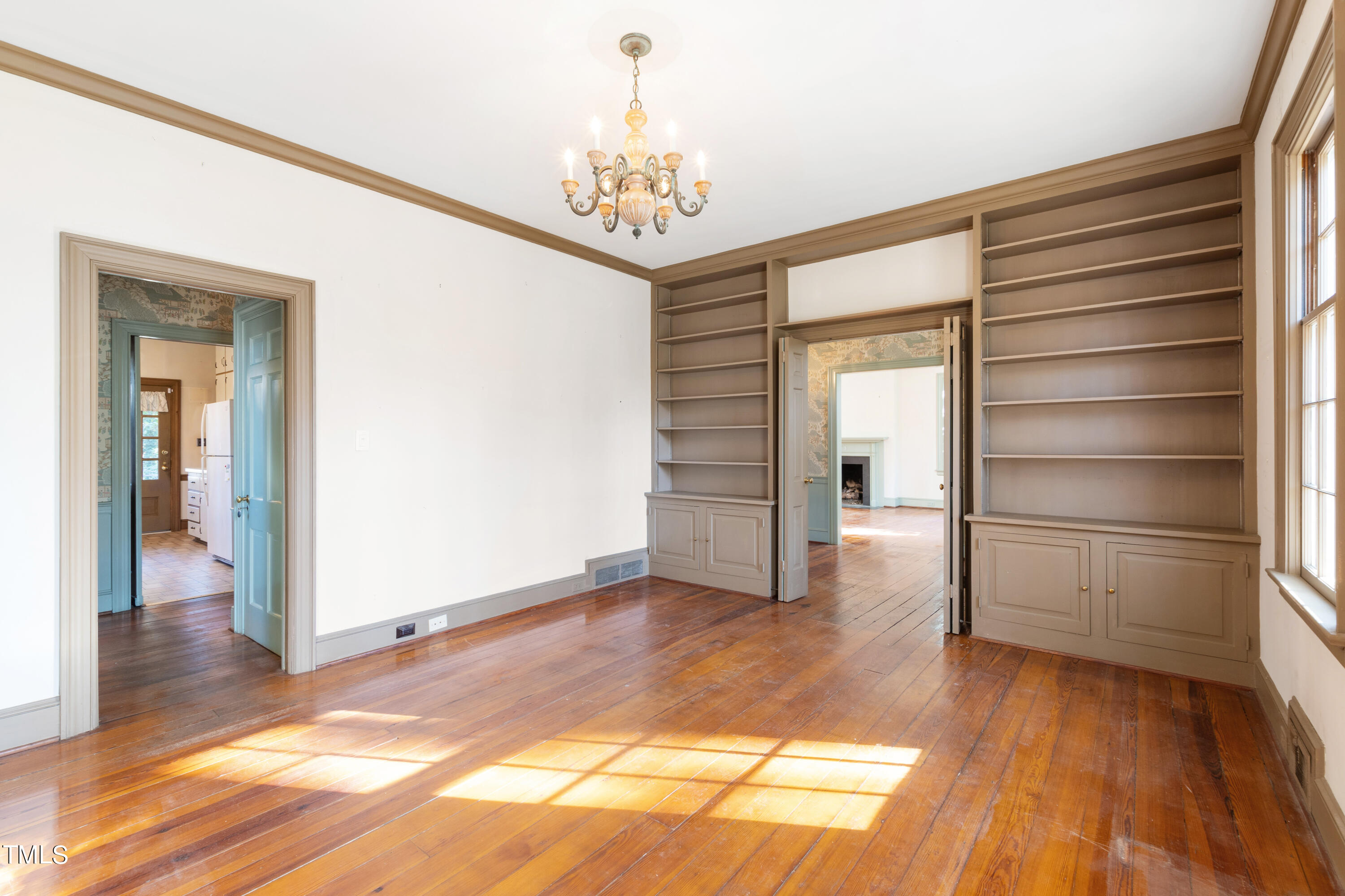 2522 Wake Drive Raleigh, NC 27608 - Photo 12 of 49 a view of a hallway with wooden floor and a chandelier
