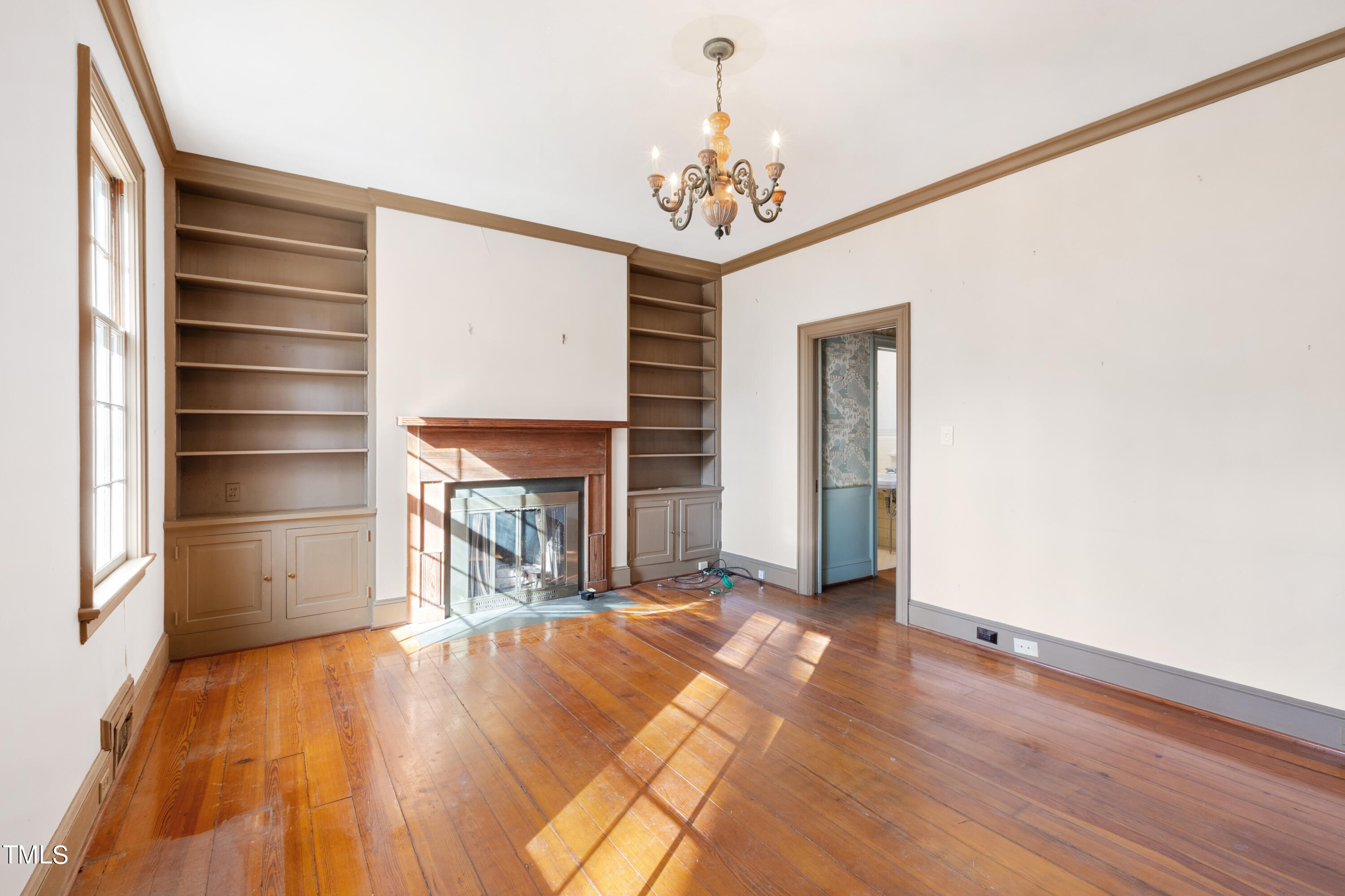 2522 Wake Drive Raleigh, NC 27608 - Photo 13 of 49 a view of a hallway with wooden floor and a chandelier