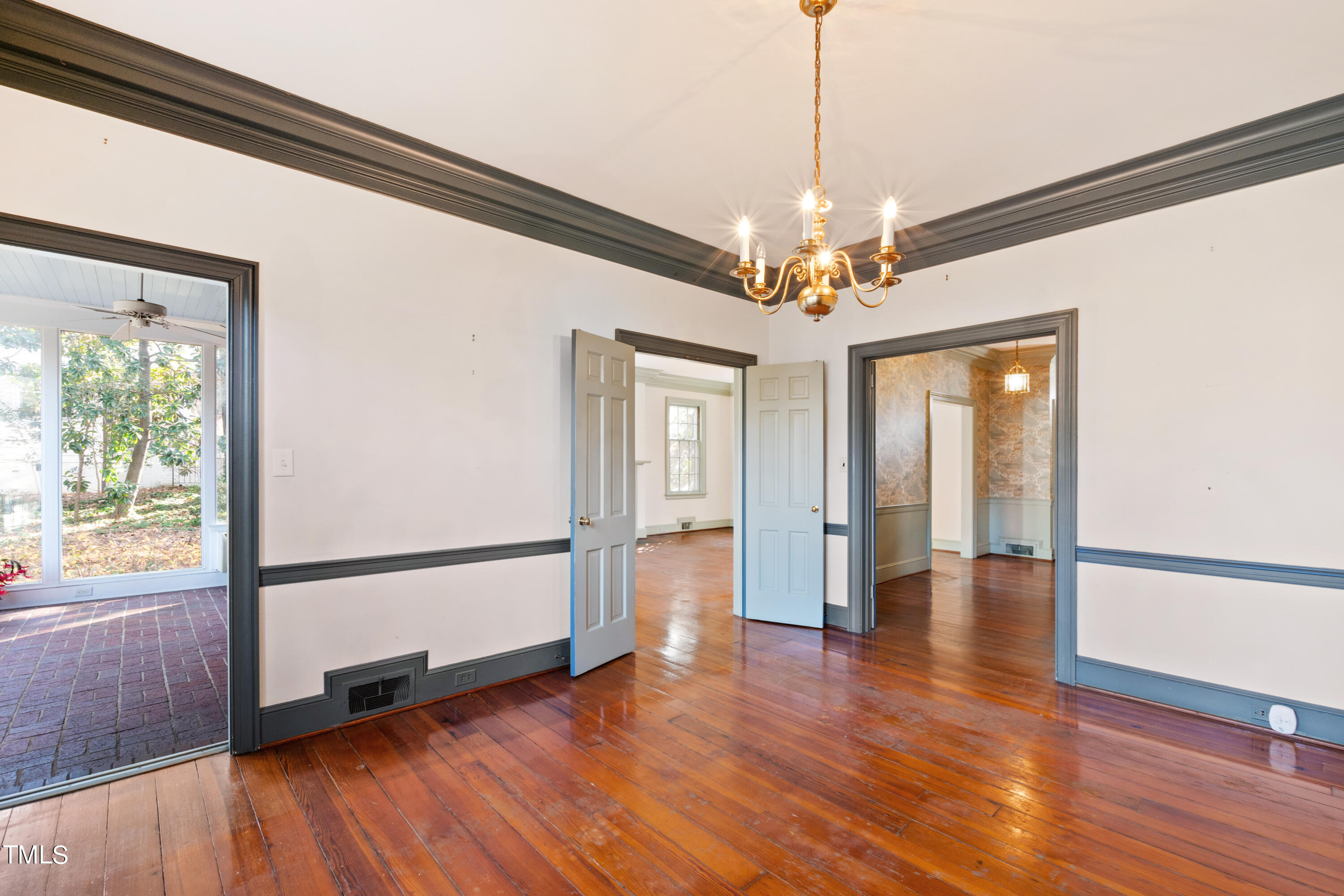 2522 Wake Drive Raleigh, NC 27608 - Photo 15 of 49 a view of a livingroom with wooden floor a ceiling fan and windows