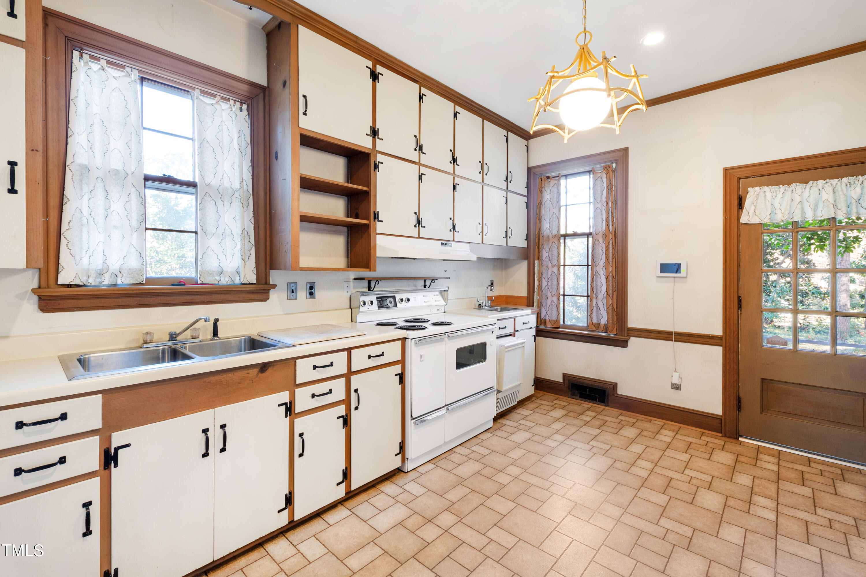 2522 Wake Drive Raleigh, NC 27608 - Photo 19 of 49 a large white kitchen with a sink and cabinets